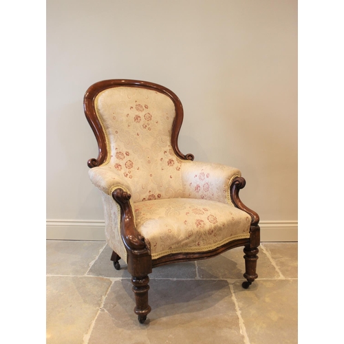 570 - A Victorian mahogany framed balloon back drawing room chair, with padded arms, scroll terminals encl... 