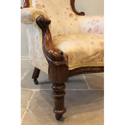 570 - A Victorian mahogany framed balloon back drawing room chair, with padded arms, scroll terminals encl... 