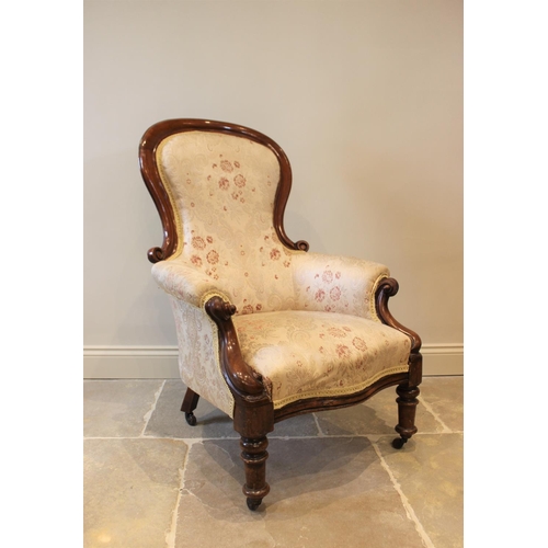 570 - A Victorian mahogany framed balloon back drawing room chair, with padded arms, scroll terminals encl... 