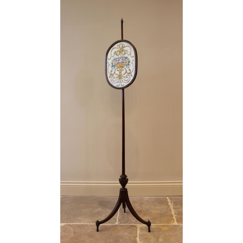 573 - A 19th century and later mahogany pole screen, the glazed oval panel applied with scrolling gold wor... 