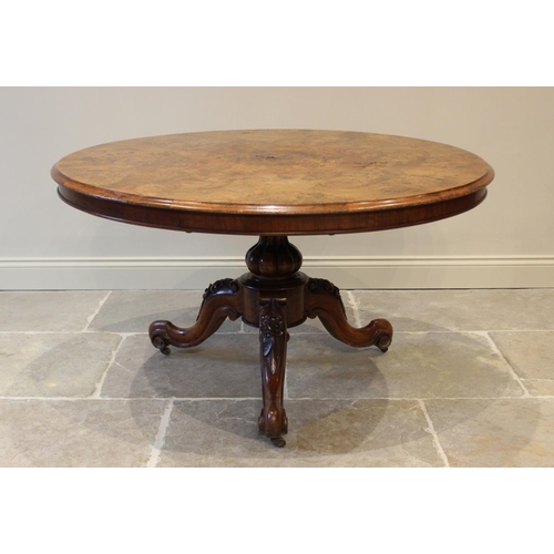 574 - A Victorian burr walnut centre table, the circular table top raised upon a lobed baluster column ext... 