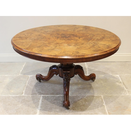 574 - A Victorian burr walnut centre table, the circular table top raised upon a lobed baluster column ext... 