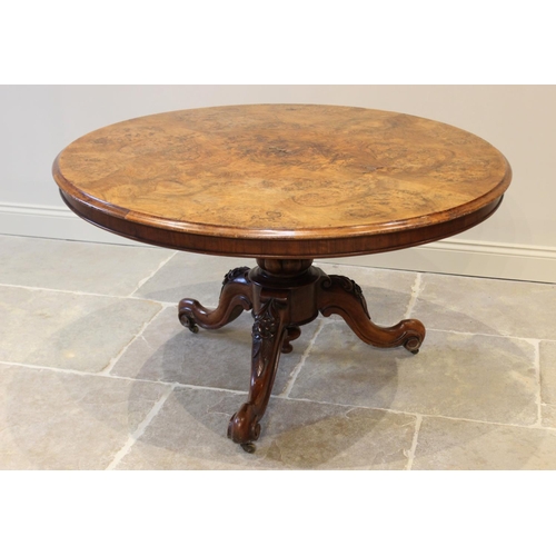 574 - A Victorian burr walnut centre table, the circular table top raised upon a lobed baluster column ext... 