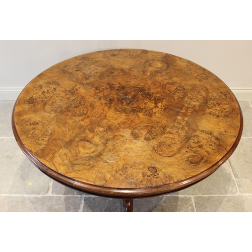 574 - A Victorian burr walnut centre table, the circular table top raised upon a lobed baluster column ext... 