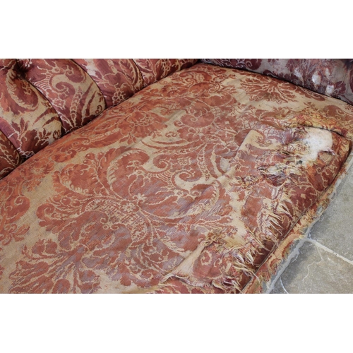 577 - A 19th century button back chesterfield type sofa, upholstered in foliate fabric and raised on turne... 