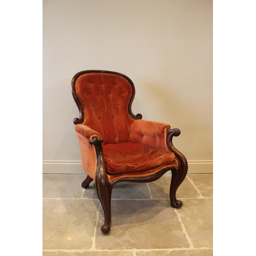 578 - A Victorian mahogany framed button back salon chair, red velour upholstery with padded arms extendin... 