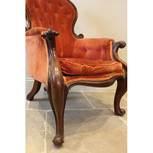 578 - A Victorian mahogany framed button back salon chair, red velour upholstery with padded arms extendin... 