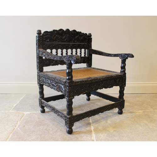 580 - A Dutch colonial Ceylonese ebony armchair, Coromandel coast, 18th/19th century, with carved lotus ba... 