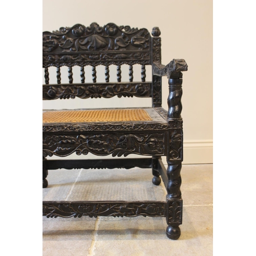 580 - A Dutch colonial Ceylonese ebony armchair, Coromandel coast, 18th/19th century, with carved lotus ba... 