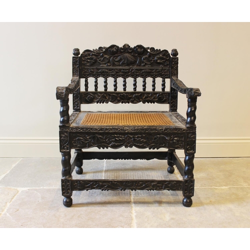 580 - A Dutch colonial Ceylonese ebony armchair, Coromandel coast, 18th/19th century, with carved lotus ba... 