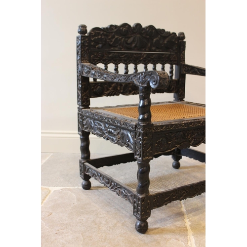 580 - A Dutch colonial Ceylonese ebony armchair, Coromandel coast, 18th/19th century, with carved lotus ba... 