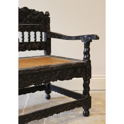 580 - A Dutch colonial Ceylonese ebony armchair, Coromandel coast, 18th/19th century, with carved lotus ba... 