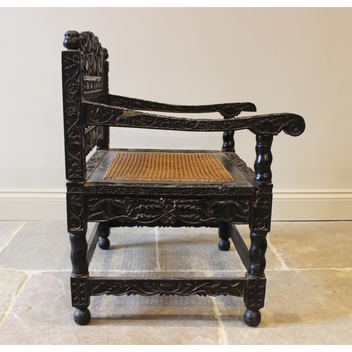 580 - A Dutch colonial Ceylonese ebony armchair, Coromandel coast, 18th/19th century, with carved lotus ba... 