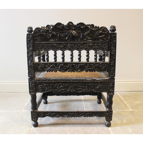 580 - A Dutch colonial Ceylonese ebony armchair, Coromandel coast, 18th/19th century, with carved lotus ba... 