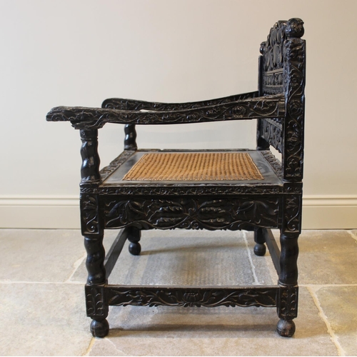 580 - A Dutch colonial Ceylonese ebony armchair, Coromandel coast, 18th/19th century, with carved lotus ba... 