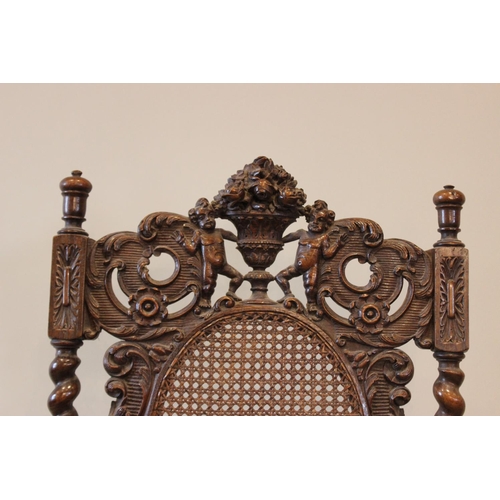 581 - A 19th century Carolean style carver chair, carved with floral bouquets flanked by cherubs, with ber... 