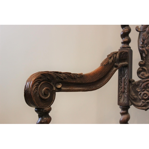 581 - A 19th century Carolean style carver chair, carved with floral bouquets flanked by cherubs, with ber... 