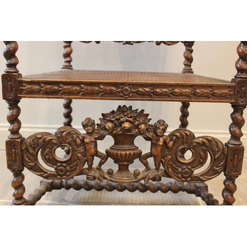 581 - A 19th century Carolean style carver chair, carved with floral bouquets flanked by cherubs, with ber... 