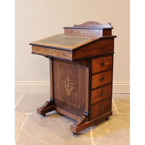 584 - A late Victorian rosewood Davenport, with hinged stationary compartment, above a leather inset fall ... 