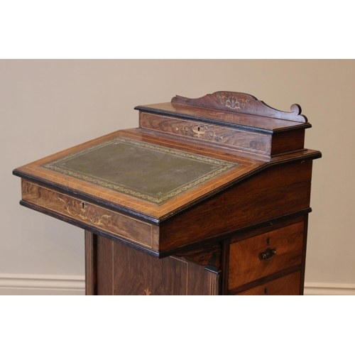 584 - A late Victorian rosewood Davenport, with hinged stationary compartment, above a leather inset fall ... 