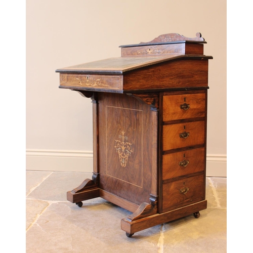 584 - A late Victorian rosewood Davenport, with hinged stationary compartment, above a leather inset fall ... 