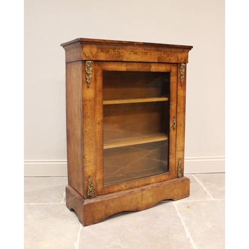 585 - An early Victorian walnut glazed pier cabinet, with inlaid frieze, above a single glazed door enclos... 