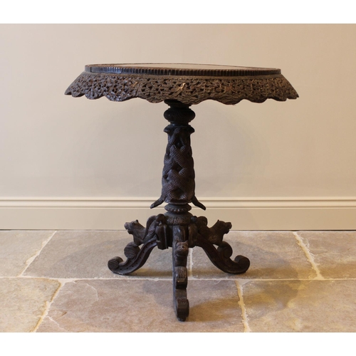 587 - A late 19th century Anglo Indian hardwood pedestal table, the circular table top carved with an oute... 