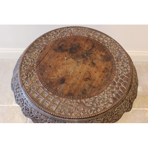 587 - A late 19th century Anglo Indian hardwood pedestal table, the circular table top carved with an oute... 