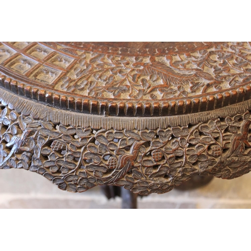 587 - A late 19th century Anglo Indian hardwood pedestal table, the circular table top carved with an oute... 