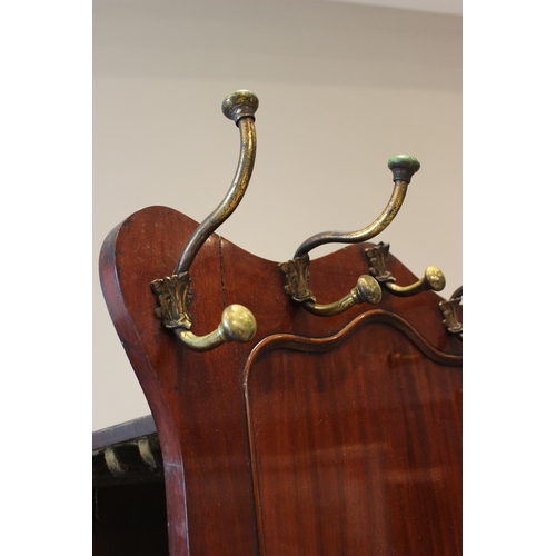 589 - A mid 19th century mahogany leaf store, combined with a hall stand, the serpentine side panel mounte... 