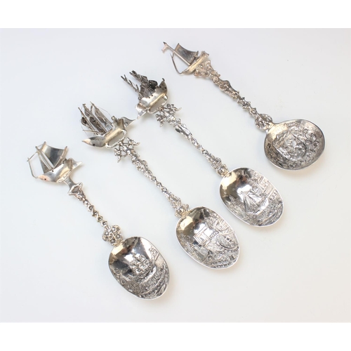 59 - Three Dutch silver spoons, each designed with pictorial bowl depicting harbour, lock and light house... 