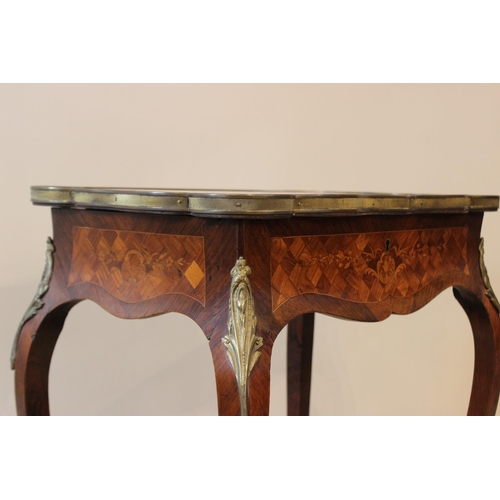 595 - A French Louis XVI style kingwood vanity table, the serpentine rectangular top with marquetry and pa... 