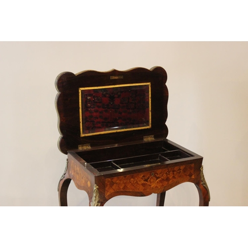 595 - A French Louis XVI style kingwood vanity table, the serpentine rectangular top with marquetry and pa... 