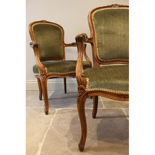 597 - A pair of French stained beech framed fauteuils, late 19th century, each upholstered in green velour... 