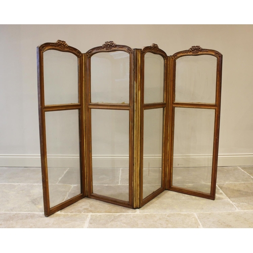 598 - An early 20th century French four fold screen, each panel with a moulded foliate crest above two gla... 