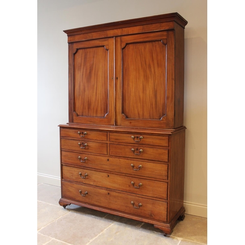 599 - A mid 19th century mahogany linen press, the moulded cornice above a pair of invert moulded cupboard... 