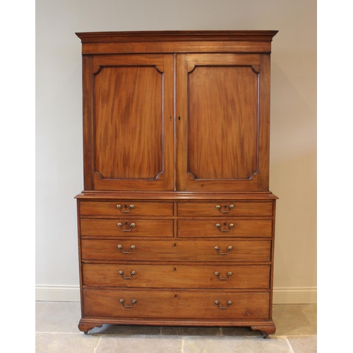 599 - A mid 19th century mahogany linen press, the moulded cornice above a pair of invert moulded cupboard... 