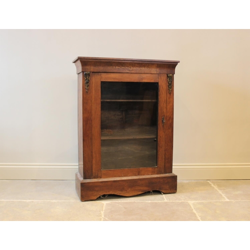 602 - A Victorian walnut pier cabinet, with foliate inlaid motif above a single glazed door, enclosing two... 