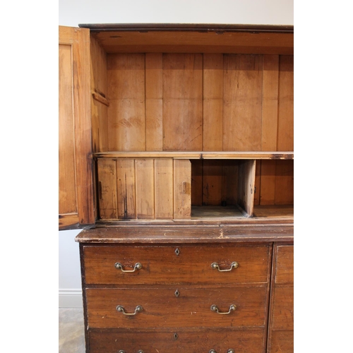 602A - A Victorian stained pine housekeepers cupboard, with an arrangement of twin two door cupboards upon ... 