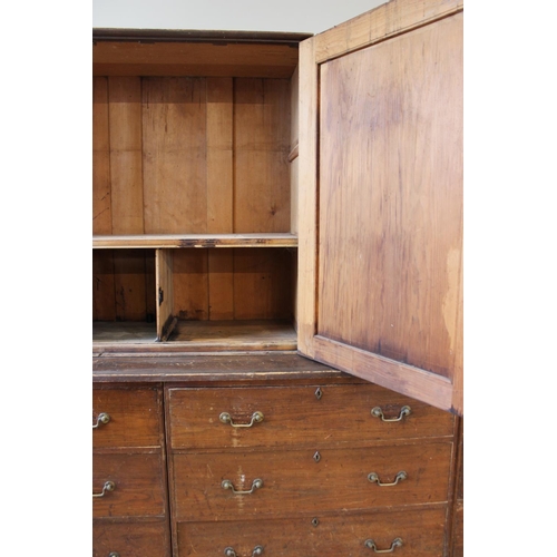 602A - A Victorian stained pine housekeepers cupboard, with an arrangement of twin two door cupboards upon ... 