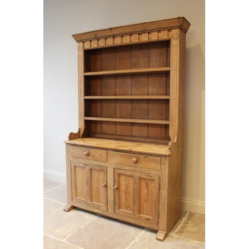 604 - A Victorian style pine kitchen dresser, the high back with a moulded cornice above a carved frieze a... 