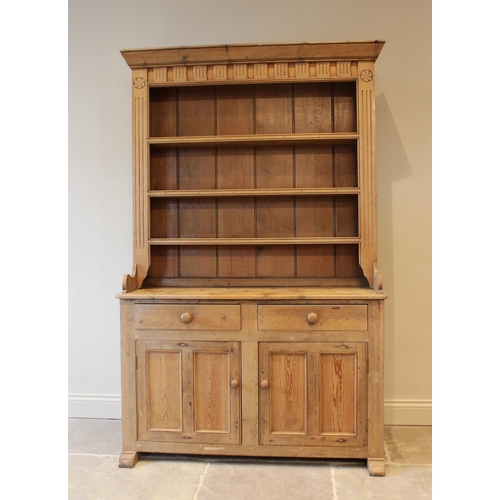 604 - A Victorian style pine kitchen dresser, the high back with a moulded cornice above a carved frieze a... 