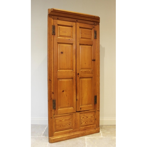 607 - A Victorian style pine free standing corner cupboard, the moulded cornice over a pair of panelled do... 