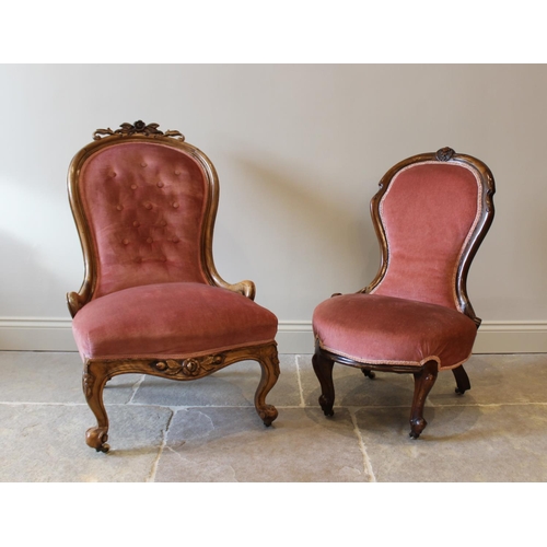 609 - A Victorian mahogany framed balloon back nursing chair, with a foliate carved crest above a pink vel... 