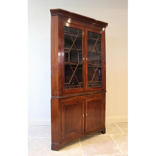 610 - A 19th century mahogany freestanding corner cabinet, the moulded cornice above a pair of astragal gl... 