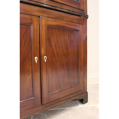 610 - A 19th century mahogany freestanding corner cabinet, the moulded cornice above a pair of astragal gl... 