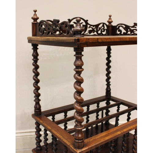 613 - An early Victorian rosewood etagere Canterbury, the four turned finials above a fretwork three quart... 