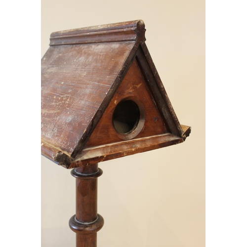 617 - A Victorian pitch pine double sided lectern, of architectural sloping form, raised upon a ring turne... 