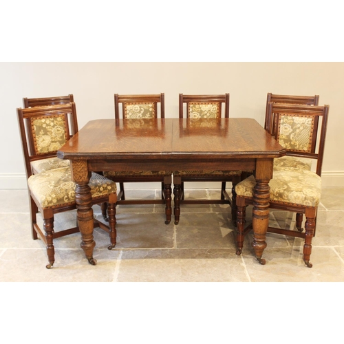 618 - An Edwardian oak extending dining table with canted corners and raised on turned baluster legs, 73cm... 