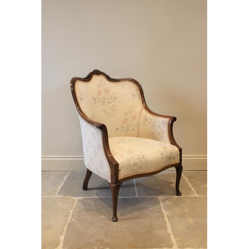 619 - An Edwardian mahogany framed tub chair, the floral pattern top above a serpentine seat raised on cab... 